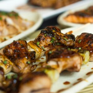 Delicious grilled meat skewers with sauce, perfect for a barbecue dish.