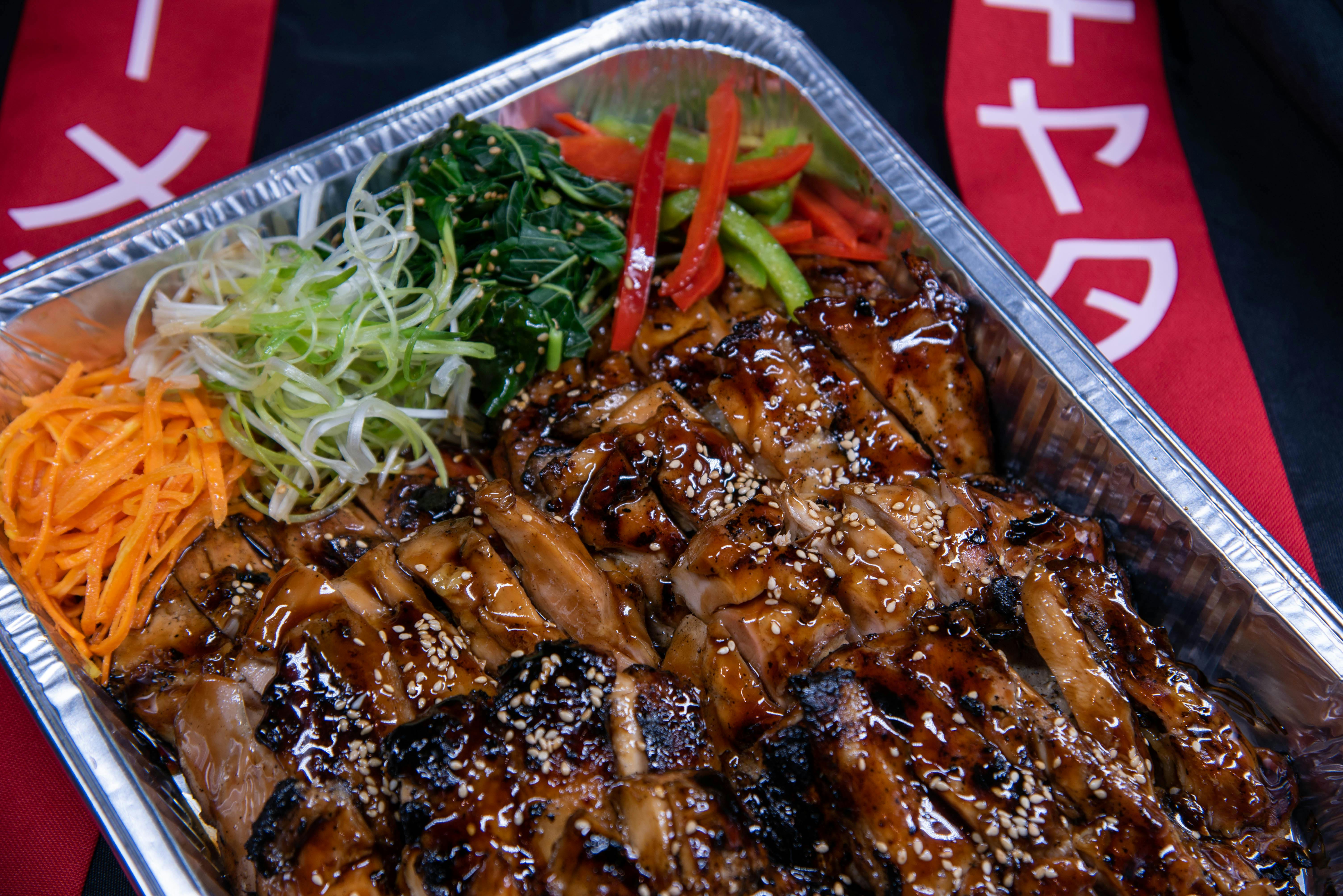 A tempting platter of teriyaki chicken with fresh vegetables, perfect for a delicious meal.